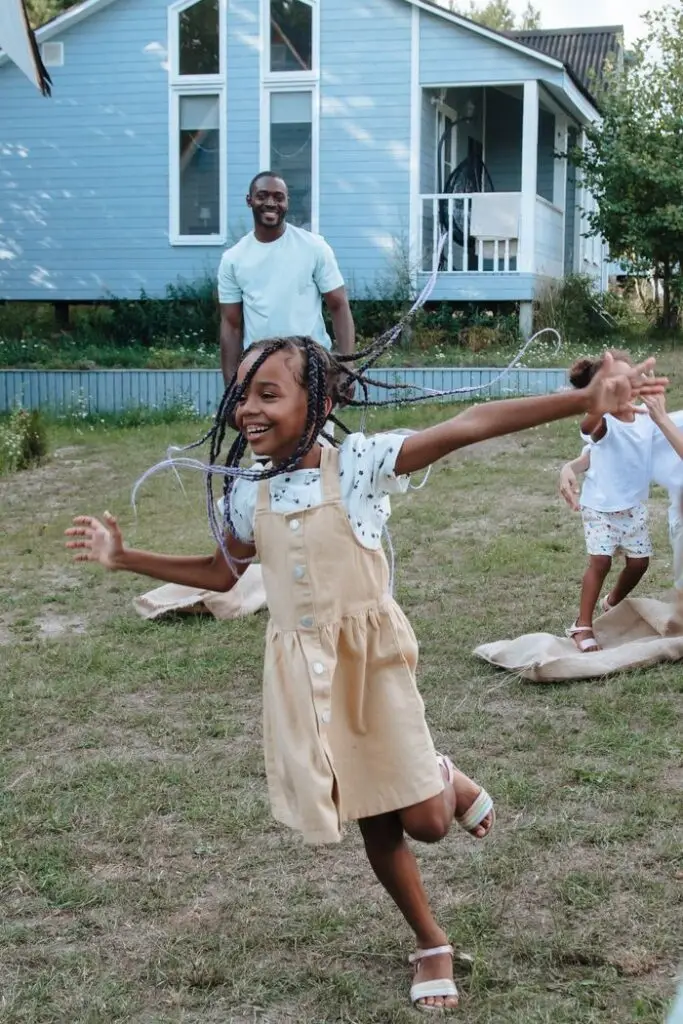 Children enjoy a playful day outdoors in a backyard, celebrating joy and togetherness.